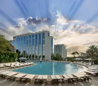 Exterior of Swissotel The Bosphorus Istanbul with pool and sun rays.