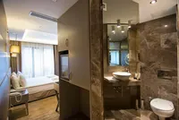 Marble-clad bathroom and bedroom view.