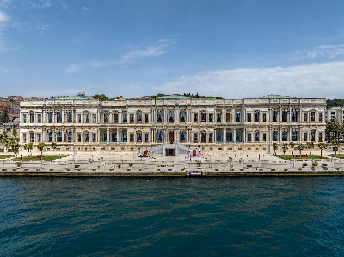 The magnificent Çırağan Palace Kempinski hotel viewed from the Bosphorus in Istanbul, showcasing its stunning Ottoman architecture.