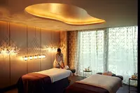 Raffles İstanbul spa odasında masaj yatakları ve sıcak aydınlatma.