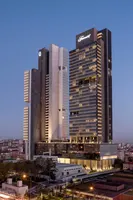 Fairmont Quasar Istanbul towers illuminated at dusk, accessible via Elemen Transfer