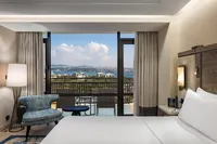 Hilton Istanbul Bosphorus guest room view overlooking the Bosphorus and balcony.