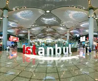 Large Istanbul sign in the airport terminal with modern ceiling architecture and Elemen Transfer service.