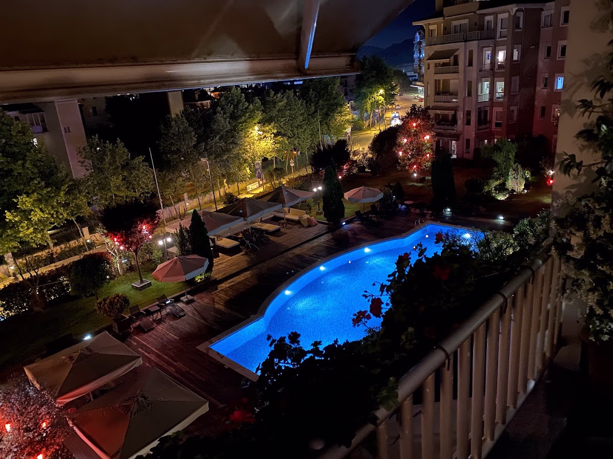 Night view of the Beyaz Konaklar swimming pool and complex from a balcony.