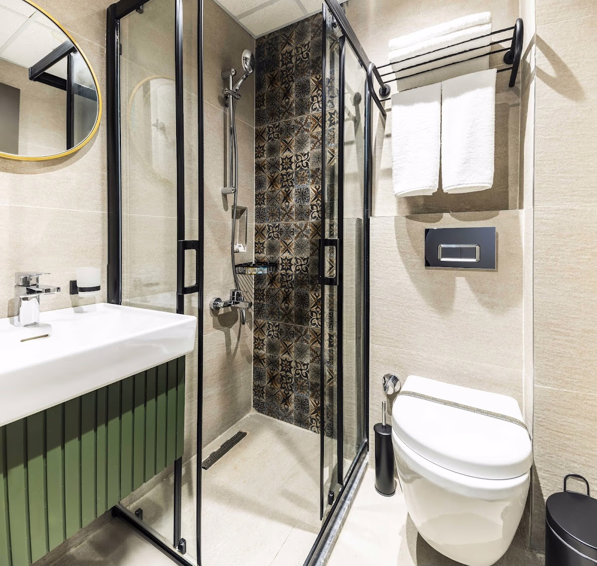 Sistina Old City Hotel'de cam duşakabin, yeşil lavabo dolabı ve desenli fayanslara sahip modern banyo.
